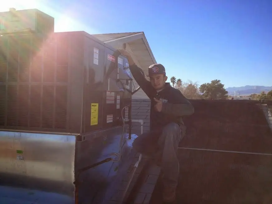 HVAC technician performing Air Duct Cleaning on a rooftop unit in Haddonfield